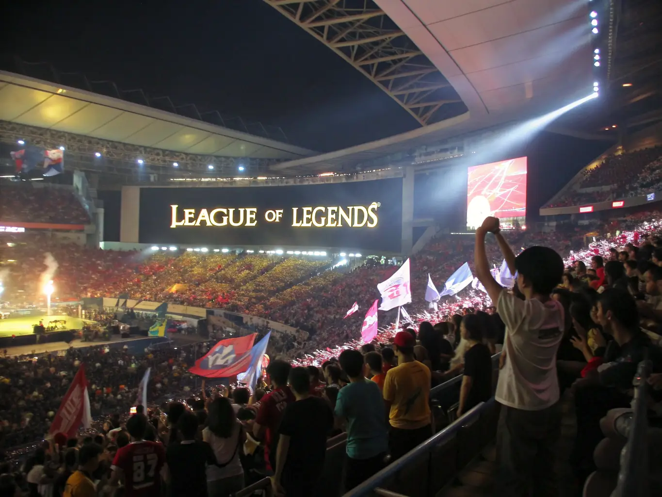 A dynamic image showcasing a League of Legends tournament with a packed stadium and intense gameplay on the big screen, reflecting the excitement of eSports events.