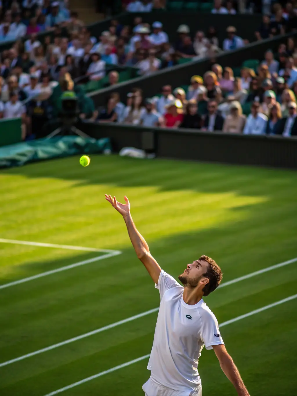 A dynamic image of a tennis match, featuring a player serving the ball with intense focus. This image represents the tennis betting options available on GGBBBET.